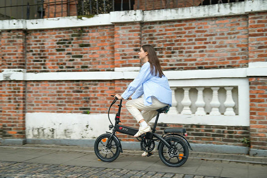 dyu a1f pro foldable electric bike in black with female rider in old town street