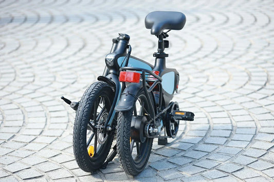 DYU C2 folded compact e-bike stored in a hallway corner
