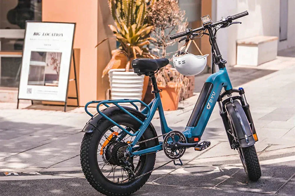 dyu ff500 blue fat tire step-through electric bike parked on city street